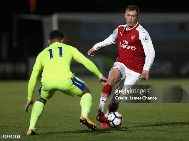 Krystian Bielik of Arsenal attempts to get past Mason Bennett of Derby during the Premier League 2 match between Arsenal and Derby County at Meadow...