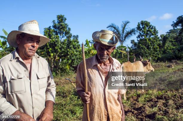 Farmer Juanito left and Nino posing for a photo on November 9, 2017 in Vinales, Cuba.