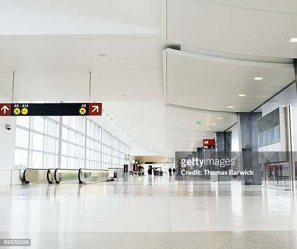concourse at airport terminal - airport terminal interior stock-fotos und bilder