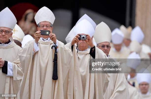 Rom, Vatikan Heiligsprechung Papst Johannes Paul II und Papst Johannes XXIII Bischoefe fotografieren den voll besetzten Petersplatz