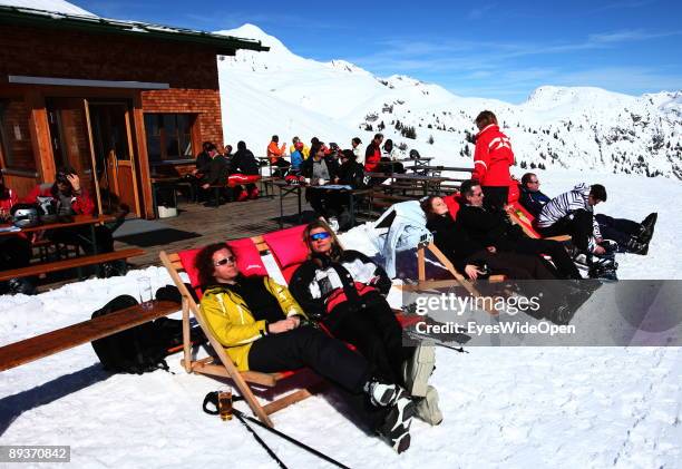 Alpine skiers sitting in front of the small hut Punchhuette in the ski region of Warther Horn on March 15, 2009 in Warth am Arlberg, Austria. Warth...