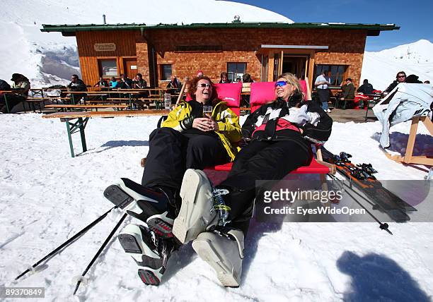 Alpine skiers sitting in front of the small hut Punchhuette in the ski region of Warther Horn on March 15, 2009 in Warth am Arlberg, Austria. Warth...