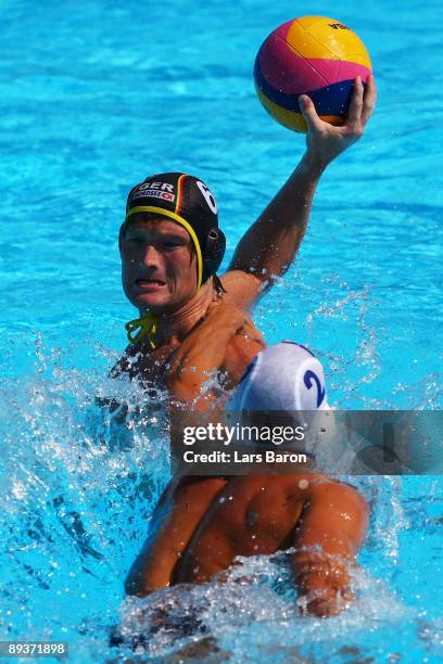 Peter Varellas of the USA tries to block the shot by Marc Politze of Germany in the Men's Water Polo Quarterfinal match between Germany and USA...