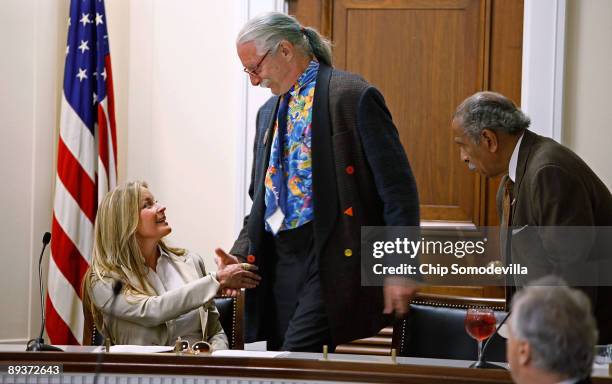 Actress and model Bo Derek greets Dr. Patch Adams, founder of the Gesundheit Institute, during during a health care reform panel discussion with...