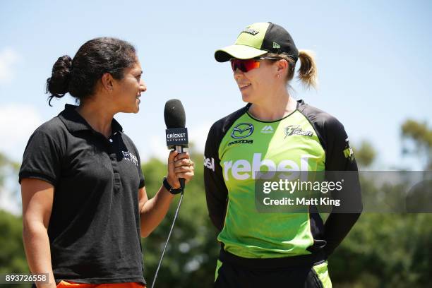 Alex Blackwell of the Thunder talks to former cricketer and commentator Lisa Sthalekar before the Women's Big Bash League match between the Melbourne...