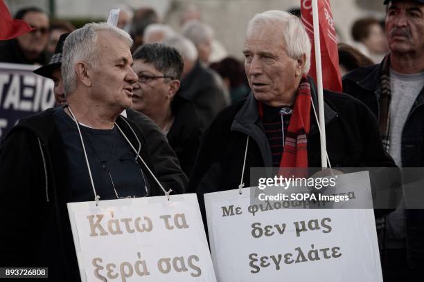 Pensioners hold placards during the protest of pensioners at Syntagma Square. They are protesting to the government of pension cuts and austerity...