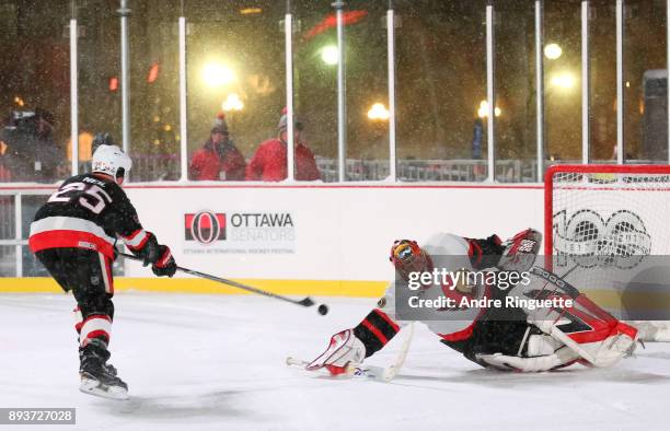 Ottawa Senators alumni Chris Neil skates in for a penalty shot on Patrick Lalime during the 2017 Scotiabank NHL100 Classic Ottawa Senators Alumni...