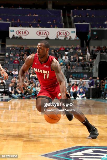 Dion Waiters of the Miami Heat handles the ball against the Charlotte Hornets on December 15, 2017 at Spectrum Center in Charlotte, North Carolina....