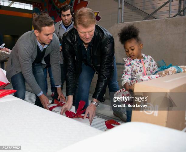 Stu Holden and Alexi Lalas hand out gifts during the Kick in for Houston participants and Leesa Sleep surprise familes affected by Hurricane Harvey...