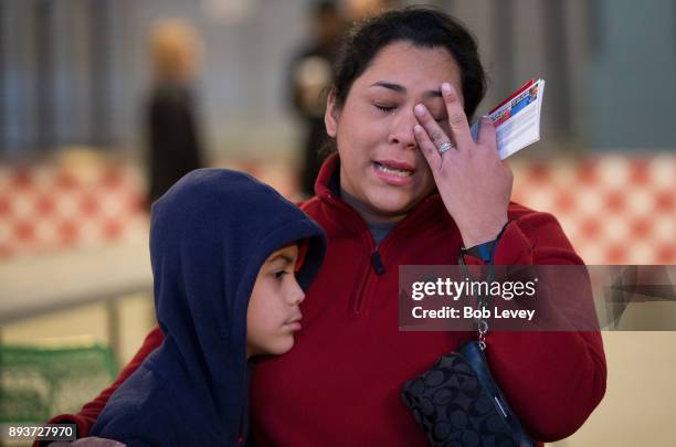 Diane Morales wipes tears from her eyes as she thanks everyone for her gifts during the Kick in for Houston participants and Leesa Sleep surprise...