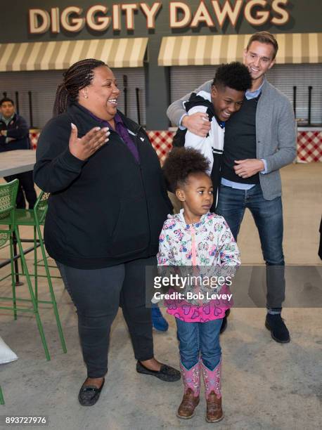 Stu Holden celebrates with Patrizia McQueen and family during the Kick in for Houston participants and Leesa Sleep surprise familes affected by...
