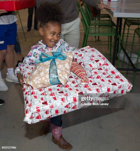 Families receive their gift during the Kick in for Houston participants and Leesa Sleep surprise familes affected by Hurricane Harvey with gifts at...