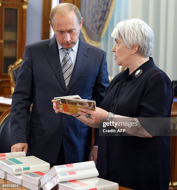 The widow of famous Russian writer Alexander Solzhenitsyn, Natalya Solzhenitsyna shows books to Russian Premier Vladimir Putin during their meeting...