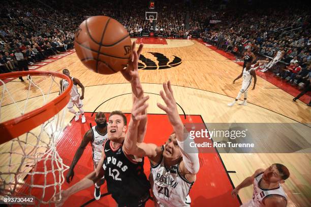 Jakob Poeltl of the Toronto Raptors dunks against Timofey Mozgov of the Brooklyn Nets on December 15, 2017 at the Air Canada Centre in Toronto,...