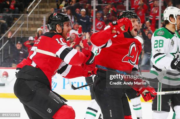 Nick Lappin of the New Jersey Devils reacts with teammate Jimmy Hayes after scoring a goal against the Dallas Stars during the game at Prudential...