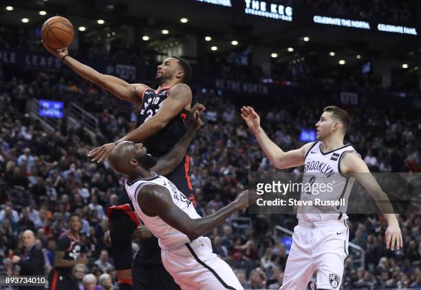 Toronto Raptors forward Norman Powell puts up a shot over Brooklyn Nets forward Quincy Acy as the Toronto Raptors beat the Brooklyn Nets at the Air...