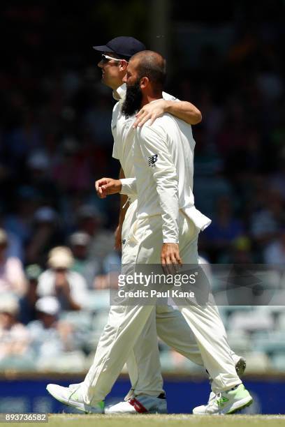 Alistair Cook of England walks down the pitch with Moeen Ali after dismissing Shaun Marsh of Australia during day three of the Third Test match...