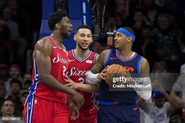 Joel Embiid of the Philadelphia 76ers and Carmelo Anthony of the Oklahoma City Thunder exchange words in front of Ben Simmons of the Philadelphia...