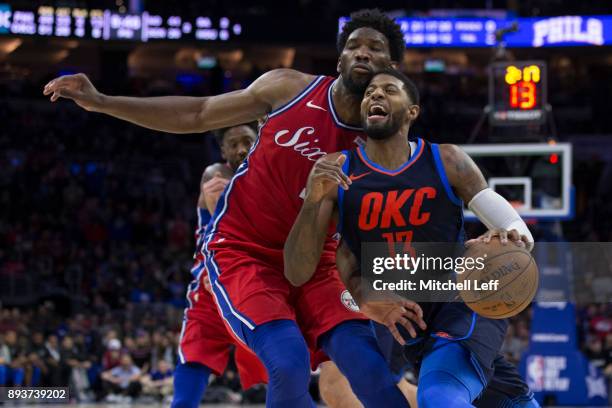Paul George of the Oklahoma City Thunder drives to the basket against Joel Embiid of the Philadelphia 76ers in double overtime at the Wells Fargo...
