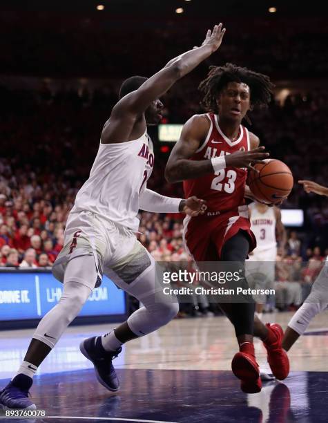 John Petty of the Alabama Crimson Tide drives the ball against Rawle Alkins of the Arizona Wildcats during the first half of the college basketball...