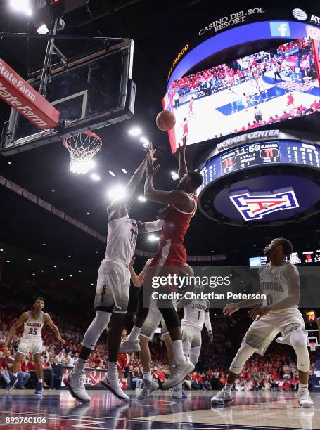 Daniel Giddens of the Alabama Crimson Tide attempts a shot over Deandre Ayton of the Arizona Wildcats during the first half of the college basketball...