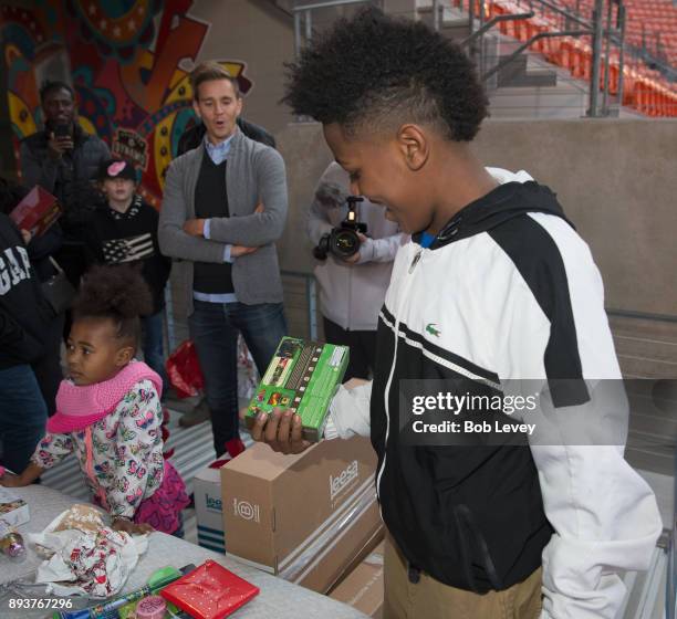 Stu Holden reacts to families receiving gifts during the Kick in for Houston participants and Leesa Sleep surprise familes affected by Hurricane...