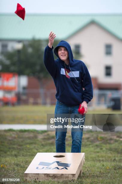 An attendee plays a game of cornhole during Base*FEST Powered by USAA on December 15, 2017 at Naval Air Station Pensacola, Florida.