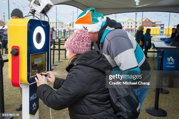 Attendees have a photo taken during Base*FEST Powered by USAA on December 15, 2017 at Naval Air Station Pensacola, Florida. (Photo by Michael...