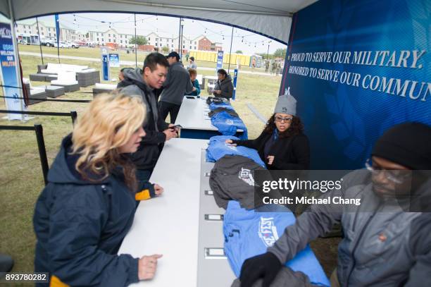 Attendees get their shirts during Base*FEST Powered by USAA on December 15, 2017 at Naval Air Station Pensacola, Florida.