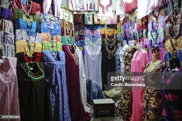 Vendor waits for customers at a clothing stall in Mumbai, India, on Friday, Dec. 15, 2017. India's inflation surged past the central bank's target,...