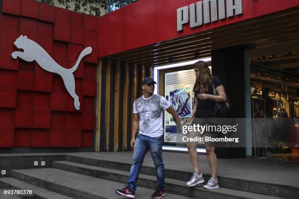 Shoppers exit a Puma SE store in Mumbai, India, on Friday, Dec. 15, 2017. India's inflation surged past the central bank's target, bolstering a view...