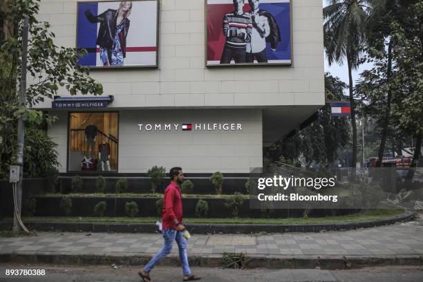 Pedestrian walks past a Tommy Hilfiger Corp. Store in Mumbai, India, on Friday, Dec. 15, 2017. India's inflation surged past the central bank's...