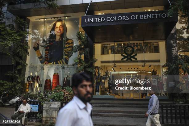 Pedestrians walk past a Benetton Group Srl United Colors of Benetton store in Mumbai, India, on Friday, Dec. 15, 2017. India's inflation surged past...