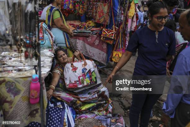 Roadside vendor waits for customers at a market in Mumbai, India, on Friday, Dec. 15, 2017. India's inflation surged past the central bank's target,...