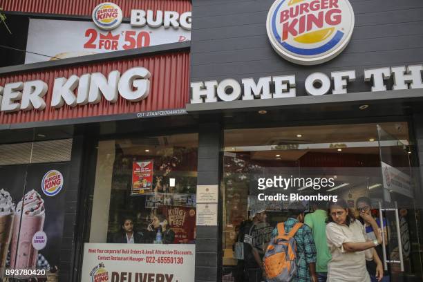 Customers exit a Burger King Corp. Fast food restaurant in Mumbai, India, on Friday, Dec. 15, 2017. India's inflation surged past the central bank's...