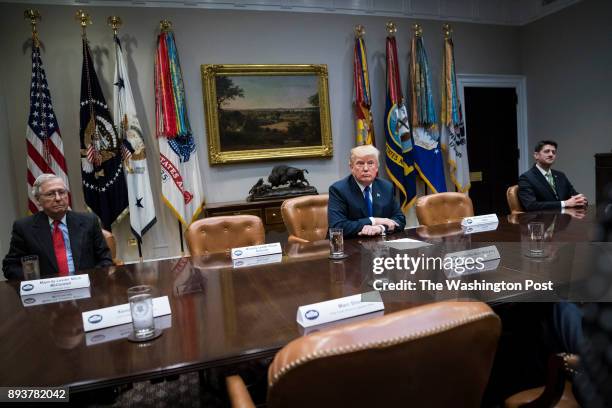 President Donald Trump speaks with House Speaker Paul Ryan of Wis., and Senate Majority Leader Mitch McConnell of Ky., by his side during a meeting...