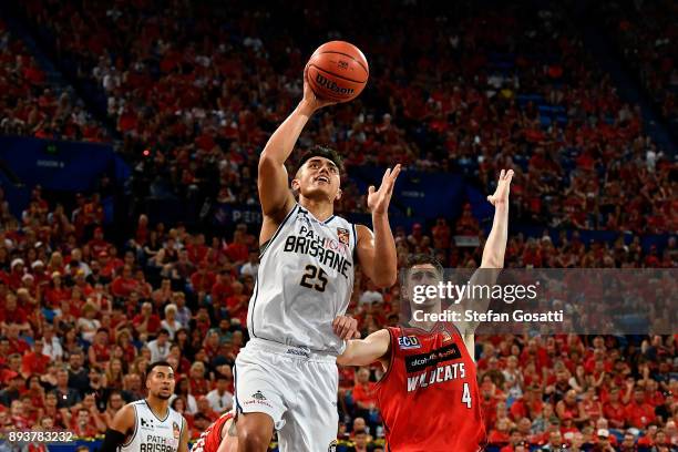 Reuben Te Rangi of the Bullets drives to the basket against Greg Hire of the Wildcats during the round 10 NBL match between the Perth Wildcats and...