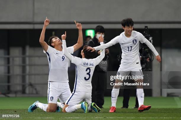 Kim Shinwook of South Korea celebrates scoring his side's first goal with his team mates Kim Jinsu and Lee Jaesung to make it 1-1 during the EAFF E-1...