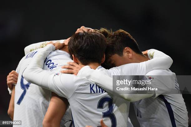Kim Shinwook of South Korea celebrates scoring his side's third goal with his team mates to make it 3-1 during the EAFF E-1 Men's Football...