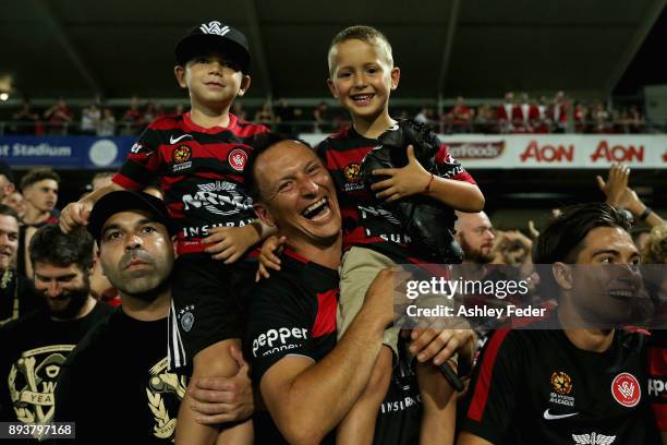 Young fan receives a pair of the players boots during the round 11 A-League match between the Central Coast and the Western Sydney Wanderers at...