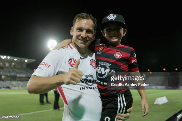 Brendon Santalab of the Wanderers celebrates the win with a young fan on the field after the game during the round 11 A-League match between the...