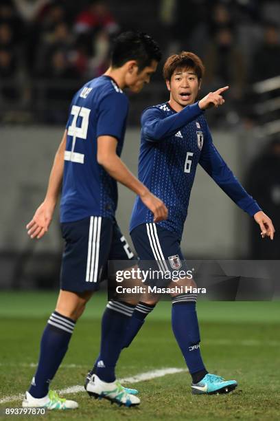 Genta Miura and Naomichi Ueda of Japan discuss during the EAFF E-1 Men's Football Championship between Japan and South Korea at Ajinomoto Stadium on...