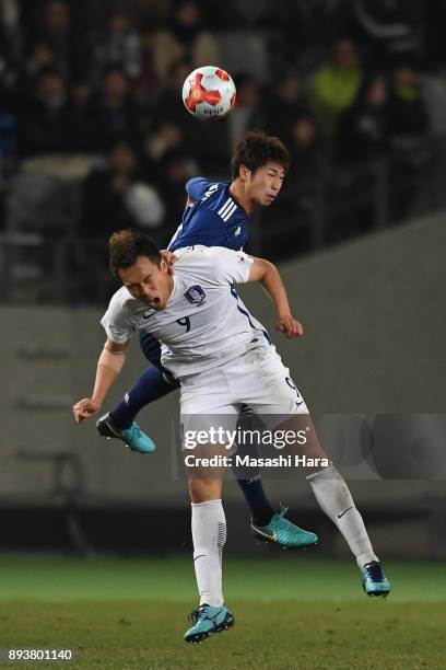 Kim Shinwook of South Korea and Genta Miura of Japan compete for the ball during the EAFF E-1 Men's Football Championship between Japan and South...