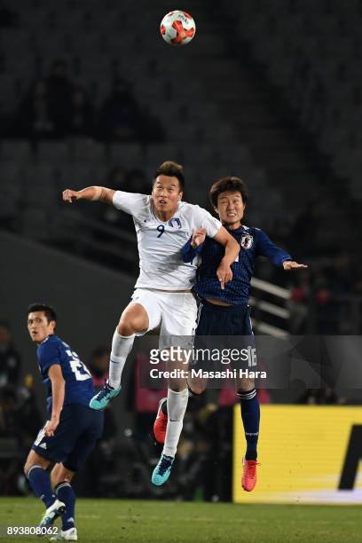 Kim Shinwook of South Korea and Kento Misao of Japan compete for the ball during the EAFF E-1 Men's Football Championship between Japan and South...