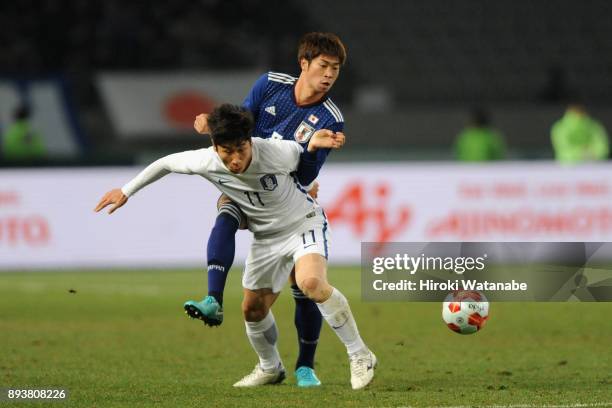 Lee Keunho of South Korea controls the ball under pressure of Genta Miura of Japan during the EAFF E-1 Men's Football Championship between Japan and...