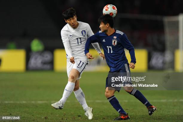 Lee Keunho of South Korea and Yasuyuki Konno of Japan compete for the ball during the EAFF E-1 Men's Football Championship between Japan and South...