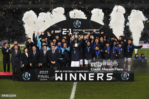 Captain Jang Hyunsoo of South Korea lifts the trophy as they celebrate the East Asian Champions at the award ceremony following their 4-1 victory in...