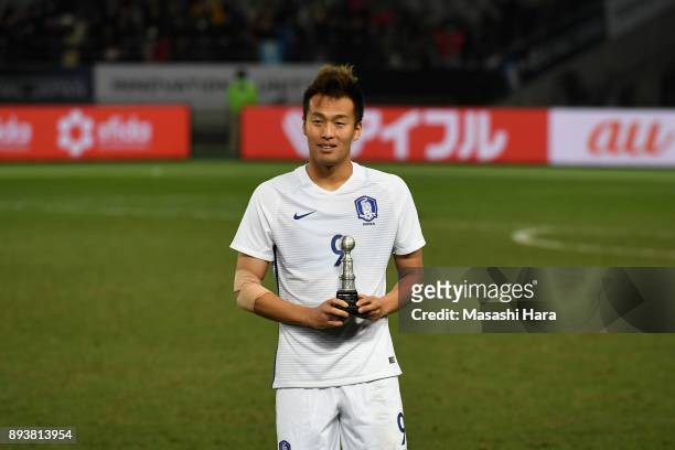 Kim Shinwook of South Korea poses for photographs after receives the Top Scorer award after the EAFF E-1 Men's Football Championship between Japan...