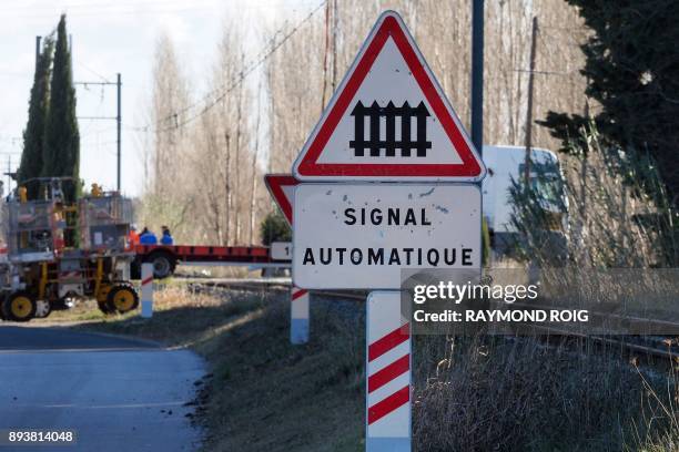 Sign announcing a level crossing is pictured in Millas as gendarmes investigate, on December 16 two days after some children were involved in an...