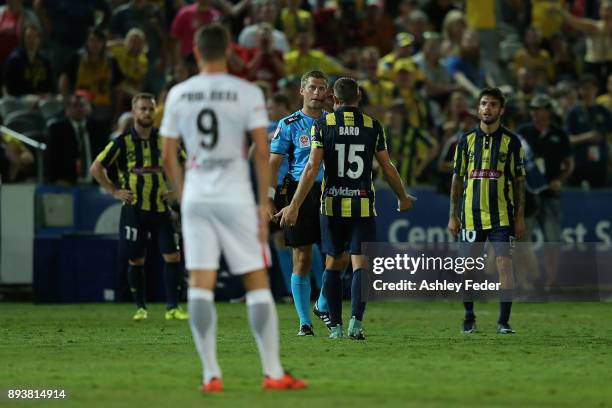 Referee Alex King talks to Alan Baro about a decision during the round 11 A-League match between the Central Coast and the Western Sydney Wanderers...